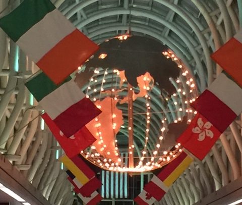 lighted globe with international flags surrounding